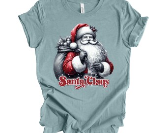 May include: A light blue t-shirt with a graphic of Santa Claus carrying a bag of gifts. The text "Santa Claus" is printed in red below the image.