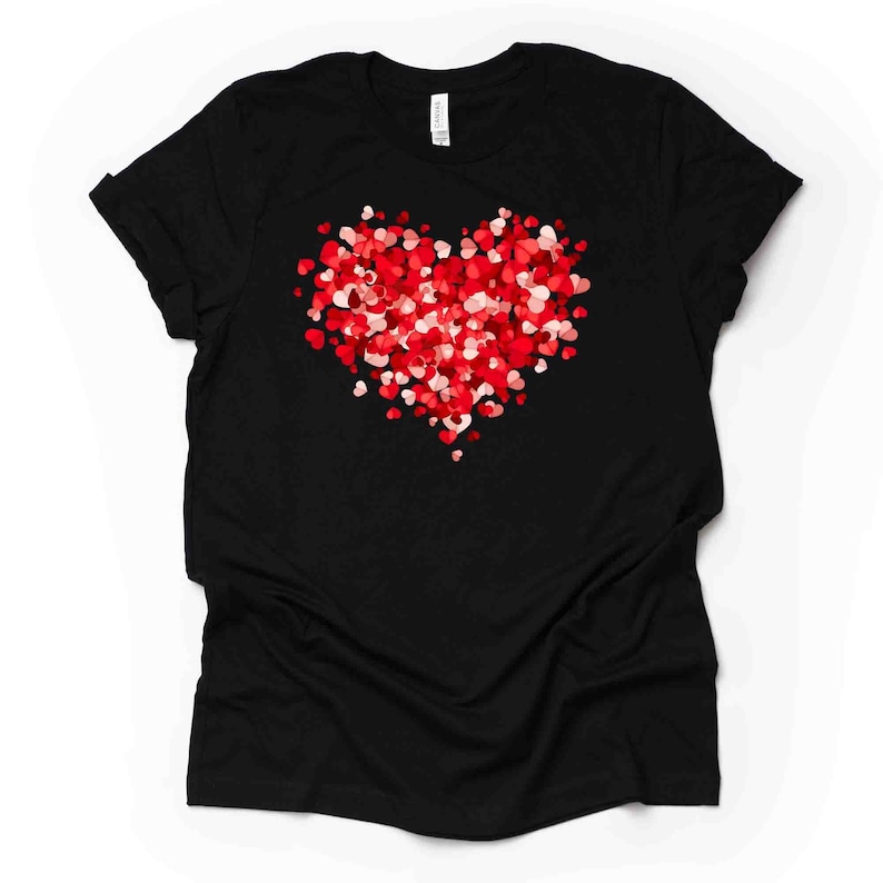 May include: Black t-shirt with a red and pink heart made of smaller hearts.