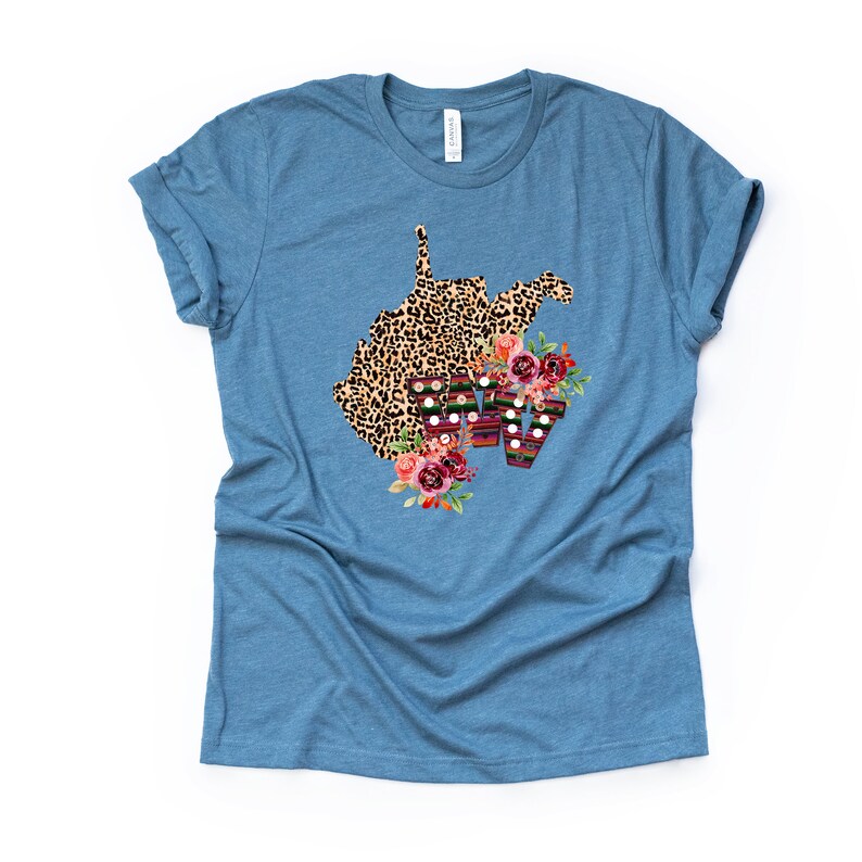 May include: A blue t-shirt with a leopard print outline of the state of West Virginia with floral accents and the letters WV in a colorful patterned font.