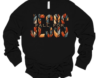 May include: Black long-sleeve shirt with a graphic design of colorful leaves spelling out "Fall for Jesus".