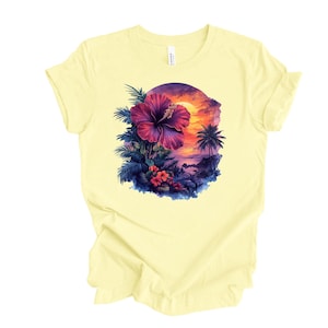 May include: A light yellow t-shirt featuring a vibrant tropical design. The graphic includes a large, deep pink hibiscus flower, palm trees, and a sunset scene. The shirt is made of soft material.
