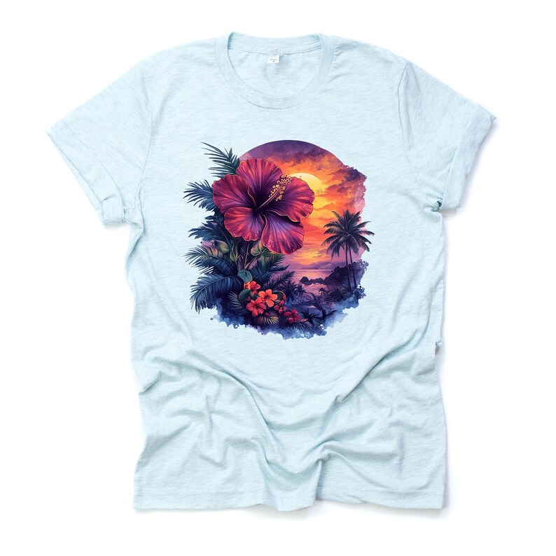 May include: Light blue t-shirt featuring a vibrant tropical design. The graphic showcases a large, deep pink hibiscus flower surrounded by lush green foliage, with a sunset scene and palm trees in the background. The design is centered on the shirt.