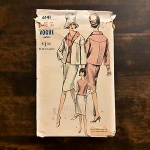 May include: Vintage Vogue pattern envelope featuring illustrations of women's suits. The envelope is off-white with the number 6141 and the Vogue logo. The illustrations depict women in stylish outfits, with text indicating the price.