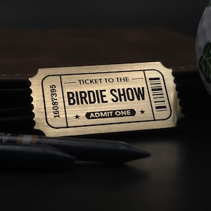 Customised Golf Ball Marker - Ticket to The Birdie Show. Made from solid metal, laser engraved.