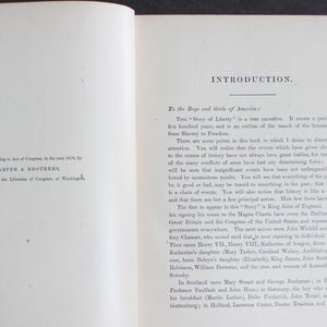 May include: An open book with text on both pages. The left page details copyright information from 1876 by Harper & Brothers. The right page has the title "INTRODUCTION" and discusses the "Story of Liberty".