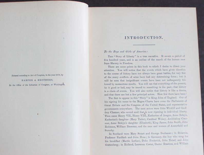 May include: An open book with text on both pages. The left page details copyright information from 1876 by Harper & Brothers. The right page has the title "INTRODUCTION" and discusses the "Story of Liberty".
