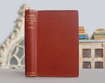 May include: A hardcover book with a solid dark red cover. The spine features gold lettering that reads Animism Magic and the Divine King, the author name Boheim, and the publisher name Kegan Paul. The book is positioned upright on a flat surface.