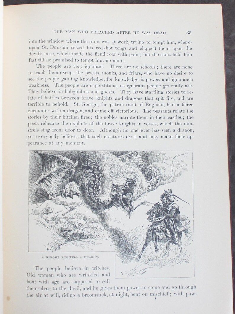 May include: A black and white illustration from a book shows a knight on horseback fighting a dragon. The knight is depicted with a raised sword, facing the dragon. The text at the bottom reads "A Knight Fighting a Dragon."