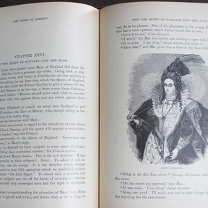 May include: A vintage book open to a chapter on the Queen of Scotland, featuring a detailed illustration of a woman in period dress. The text is in English, with the title "The Story of Liberty" visible at the top.