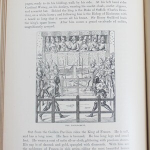 May include: A black and white illustration from a book depicting a medieval tournament. The image shows armored figures jousting in front of a crowd, with a detailed depiction of the event.