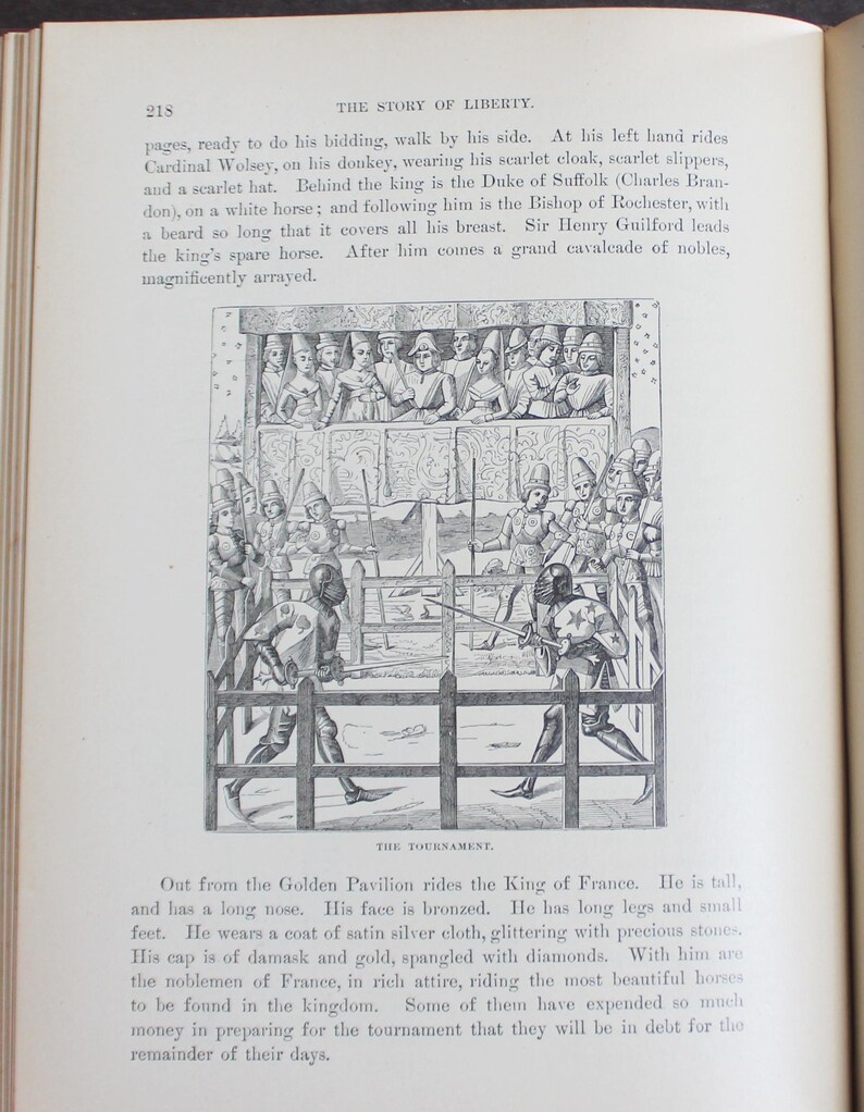 May include: A black and white illustration from a book depicting a medieval tournament. The image shows armored figures jousting in front of a crowd, with a detailed depiction of the event.