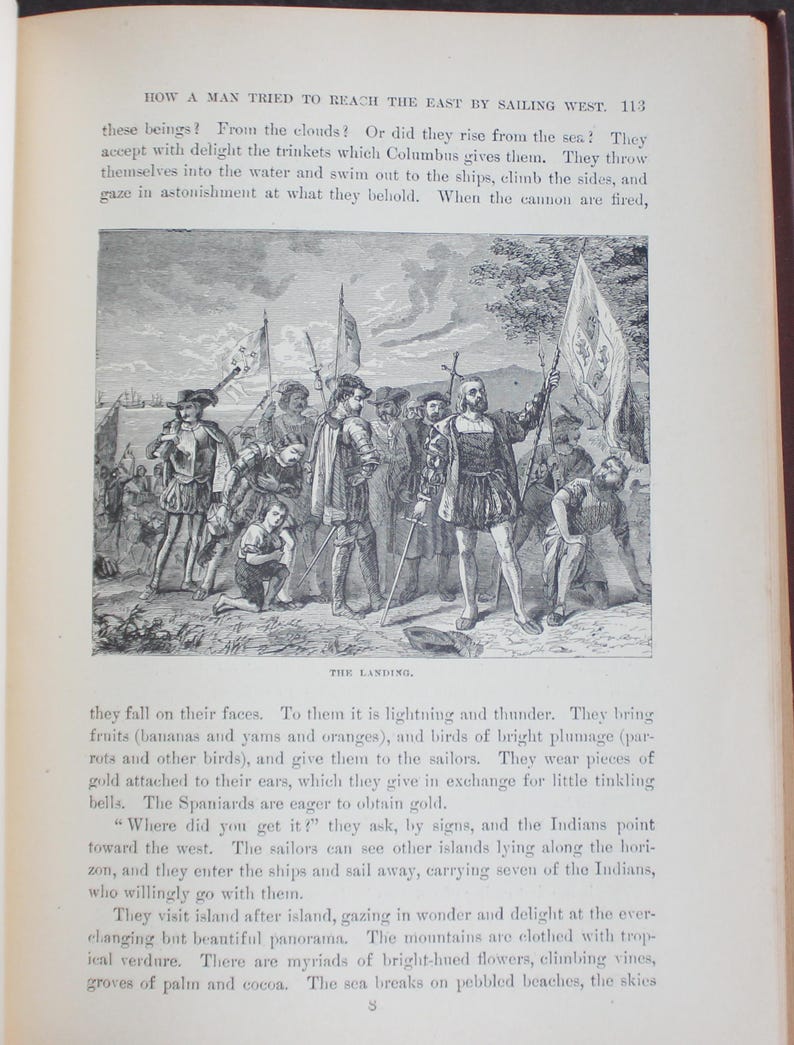 May include: A vintage black and white illustration shows explorers landing on a shore, interacting with indigenous people. The scene features figures in historical attire, holding flags. The image is from a book.