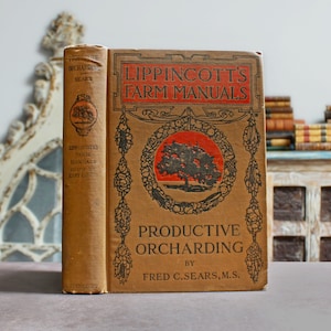 May include: A vintage book titled "Productive Orcharding" by Fred C. Sears, M.S.  The book is part of the Lippincott's Farm Manuals series and features a brown cover with an illustration of a tree and fruit.
