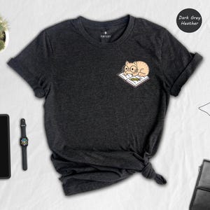 Cat And Book Lover Shirt, Sleeping Cat On Book Pocket Print, Cute Reading Cat Tee, Gift For Cat Moms And Bookworms, Unisex T-Shirt image 1