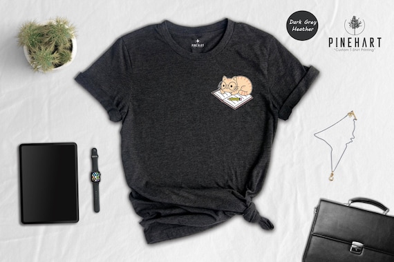 Cat And Book Lover Shirt, Sleeping Cat On Book Pocket Print, Cute Reading Cat Tee, Gift For Cat Moms And Bookworms, Unisex T-Shirt