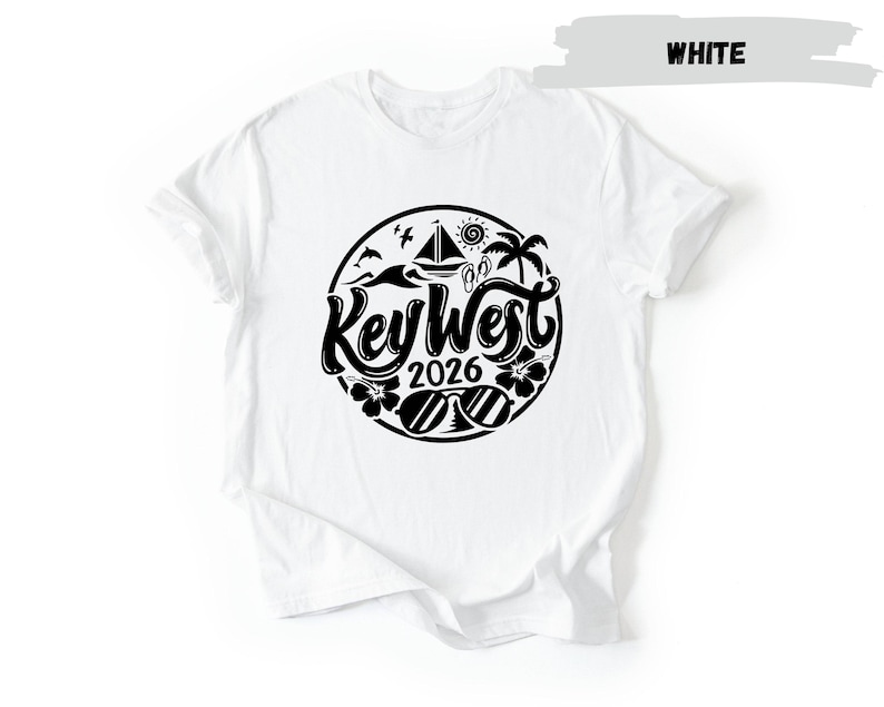 A white t-shirt with a black graphic design featuring the text "Key West 2016" surrounded by various icons and symbols associated with the location.
