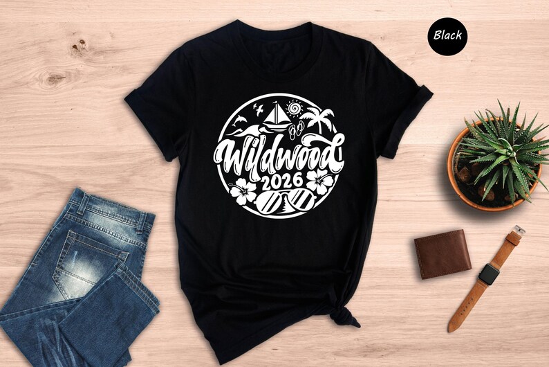 a black t-shirt with a white graphic design, a pair of blue jeans, a brown wallet, a watch, and a potted plant on a wooden surface.