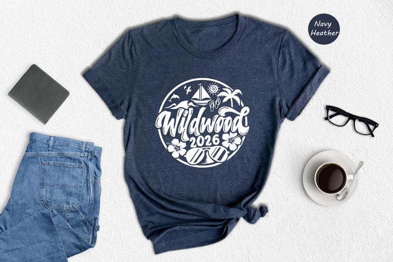 a casual outfit consisting of a navy blue t-shirt with a white graphic design, a pair of blue jeans, a black wallet, a pair of glasses, a white coffee cup, and a black pen.