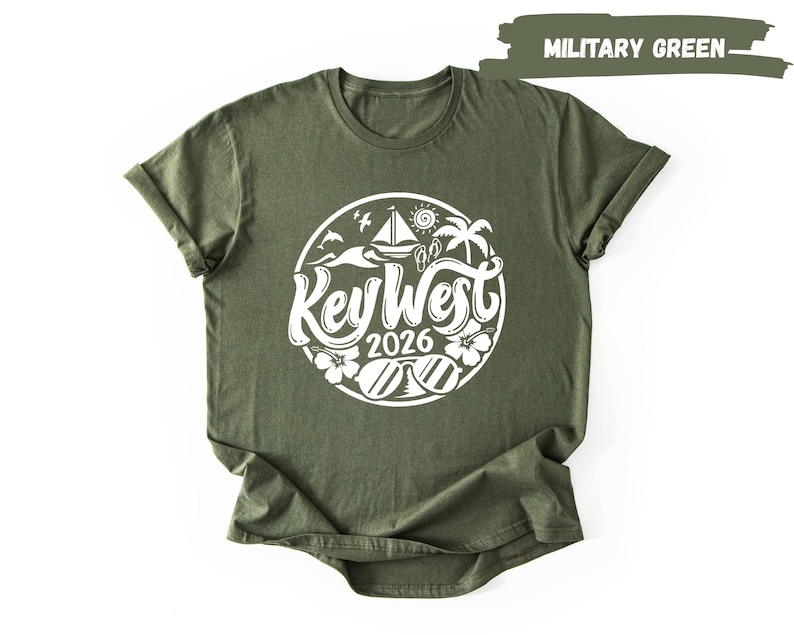 A green t-shirt with a white graphic design featuring a circular emblem with text and illustrations related to the year "2016" and the word "Key West".
