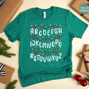 Holiday ABC Design Teacher Shirt - Festive Alphabet Lights Tee, Soft Preshrunk Cotton, Eco Friendly, Unisex Apparel
