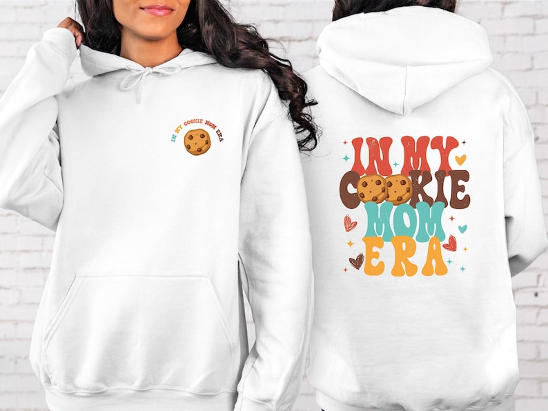 a woman wearing a white hoodie with a cookie on it