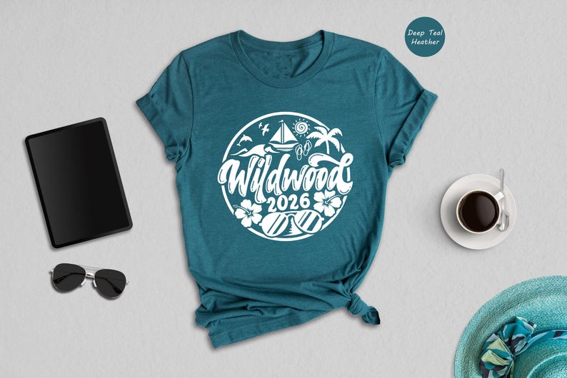 a teal t-shirt with a white graphic design, a pair of sunglasses, a tablet, a cup of coffee, and a hat, all arranged on a light gray background.