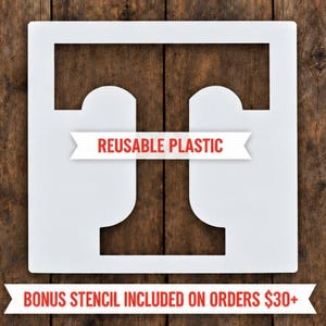May include: A square white plastic stencil featuring a large capital letter T cutout in the center. A white banner across the middle contains the red text REUSABLE PLASTIC. A second white banner at the bottom contains the red text BONUS STENCIL INCLUDED ON ORDERS $30+.