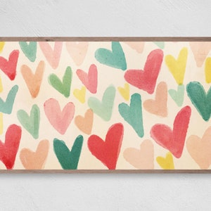May include: A digital illustration of a pattern of colourful hearts in shades of pink, red, green, yellow, and peach. The hearts are painted in a watercolour style and are arranged in a random pattern.