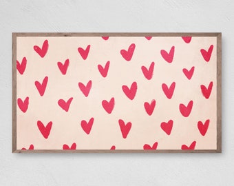 May include: A framed print with a pink background and a pattern of red hand-drawn hearts.