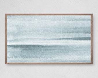 May include: Abstract watercolor art print in shades of blue and gray, framed in a natural wood. The artwork features a textured, layered design reminiscent of a landscape or seascape. The rectangular print is mounted on a white wall.