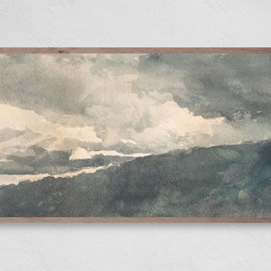 May include: A watercolor painting of a landscape with a cloudy sky. The sky is a mix of light and dark grays, with some white clouds. The landscape is a dark green, with some hills and valleys. The painting is framed in a wooden frame.