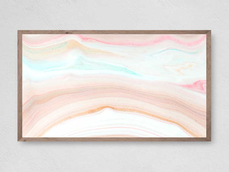 May include: Abstract art print with a swirling pattern of pink, peach, and blue colors. The print is framed in a light wood frame.