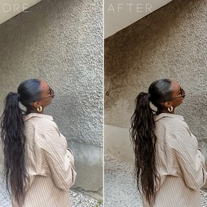 May include: A woman with long, dark hair pulled back in a ponytail is wearing a light brown striped shirt and gold hoop earrings. She is standing in front of a textured gray wall.