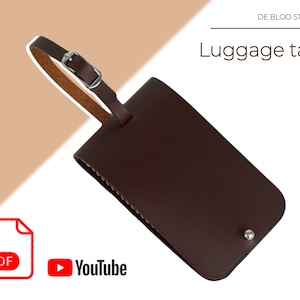 Könnte beinhalten: Braunes Leder-Gepäckanhänger mit einer silbernen Schnalle und einem silbernen Niet. Das Schild ist leer und bereit zur Personalisierung.