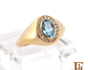 Small solid gold diamond ring with a blue Topaz