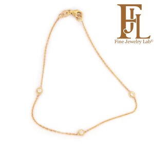 May include: A delicate gold chain bracelet with three small round diamonds.