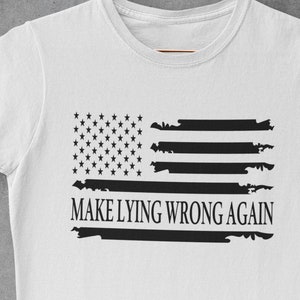 May include: White t-shirt with a black and white distressed American flag design and the text "MAKE LYING WRONG AGAIN".