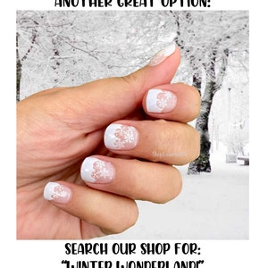 May include: White nail polish with snowflake designs. The nails have a French tip style with a white base and a delicate snowflake pattern. The image includes the text "ANOTHER GREAT OPTION:" and "SEARCH OUR SHOP FOR: WINTER WONDERLAND!"