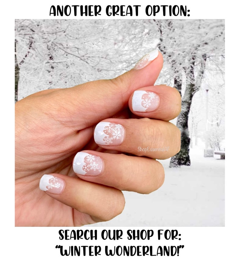May include: White nail polish with snowflake designs. The nails have a French tip style with a white base and a delicate snowflake pattern. The image includes the text "ANOTHER GREAT OPTION:" and "SEARCH OUR SHOP FOR: WINTER WONDERLAND!"