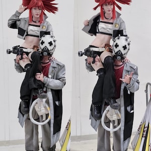 May include: Two people in cosplay costumes. One person is sitting on the shoulders of another. The person on top is wearing a red wig with large bows, a gray jacket, and a white and black top. The person on the bottom is wearing a white mask with a cross design.