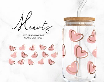 May include: A clear glass can with a wooden lid and a pink and gold heart pattern. The can has a straw and is labeled "Hearts SVG/PNG/DXF for Glass Can 16 oz".