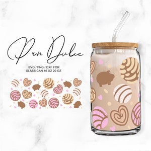 May include: A glass tumbler with a brown wooden lid and a clear straw. The tumbler is decorated with a pattern of pink and brown pan dulce, hearts, and small pigs. The text "Pan Dulce" is written in cursive at the top of the image. The text "SVG/PNG/DXF for Glass Can 16 oz 20 oz" is written below the image of the tumbler.