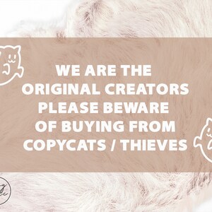 May include: A light brown background with white text that reads "WE ARE THE ORIGINAL CREATORS PLEASE BEWARE OF BUYING FROM COPYCATS / THIEVES". There are two white ghost illustrations on either side of the text.