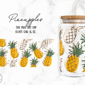 May include: A glass can with a wooden lid and a straw, decorated with a pattern of gold and green pineapples. The text "Pineapples" and "SVG PNG DXF for Glass Can 16 oz." is printed on the image.
