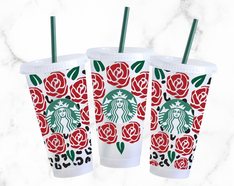 May include: Three clear plastic cups with green straws and red rose and leopard print designs. The cups feature the Starbucks logo with a green mermaid.