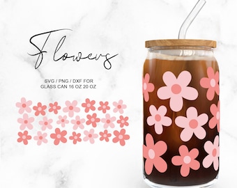 May include: A glass can with a wooden lid and a straw. The can is decorated with pink flowers. The text "flowers" is written in cursive above the can. The text "SVG/PNG/DXF FOR GLASS CAN 16 OZ 20 OZ" is written below the can.