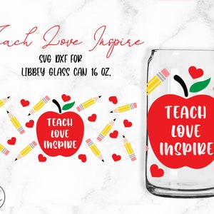 May include: Red apple with a green leaf and the text "Teach Love Inspire" on a clear glass can with a red heart and yellow pencil designs. The can is 16 ounces.