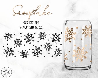 May include: A 16 oz. glass can with a snowflake design. The snowflakes are gold and there are small gold dots scattered around the can. The can is on a white faux fur background.  SVG DXF for glass can 16 oz.