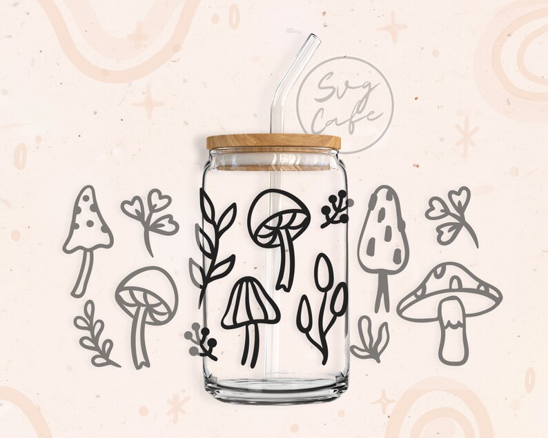 May include: A clear glass jar with a wooden lid and a black straw. The jar is decorated with black line drawings of mushrooms and leaves. The jar is sitting on a white background.