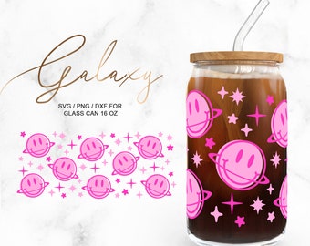 May include: A 16 oz glass can with a pink smiley face and planet design. The can has a wooden lid and a clear glass straw. The text "Galaxy" is written in cursive above the can. The text "SVG/PNG/DXF for Glass Can 16 oz" is written below the can.